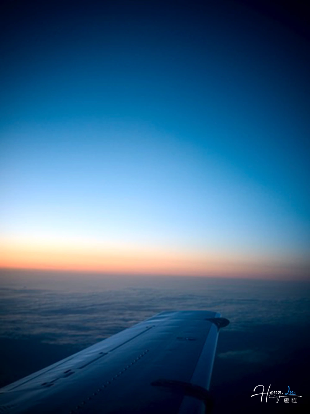 airplane-wing-above-clouds-during-sunrise
