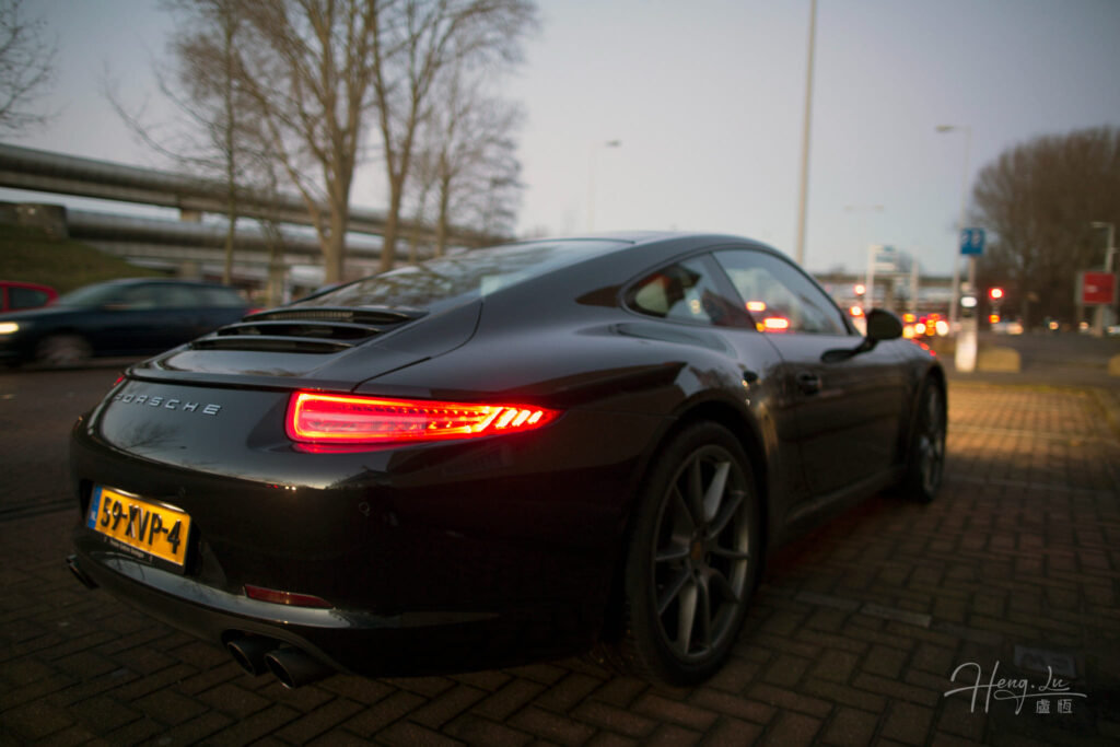 A-black-Porsche-911-with-glowing-taillights
