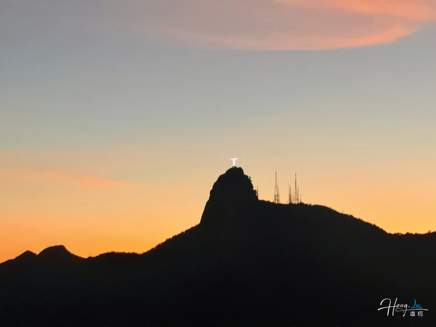 Sunset-silhouette-with-mountain-and-statue