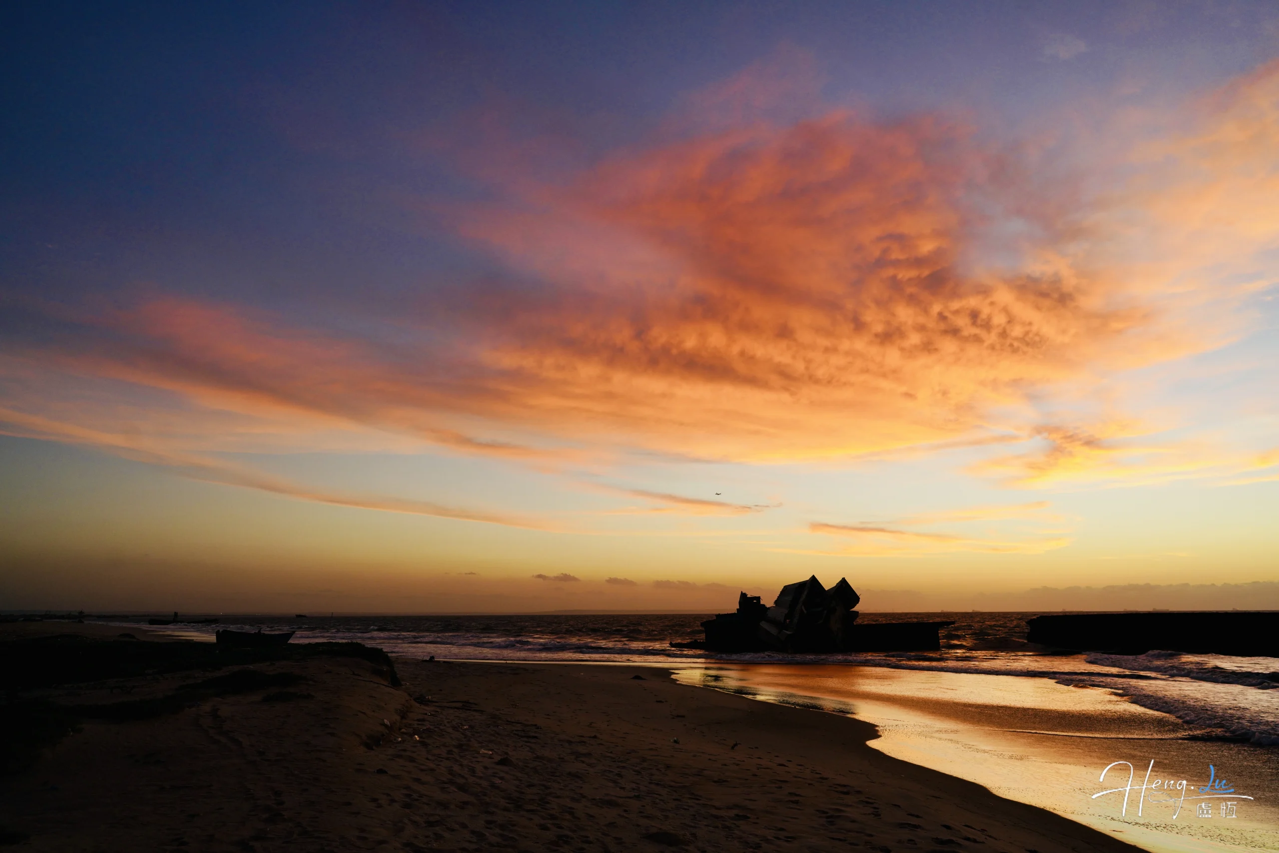 golden-sunset-with-colorful-clouds-over-seaside-wreck