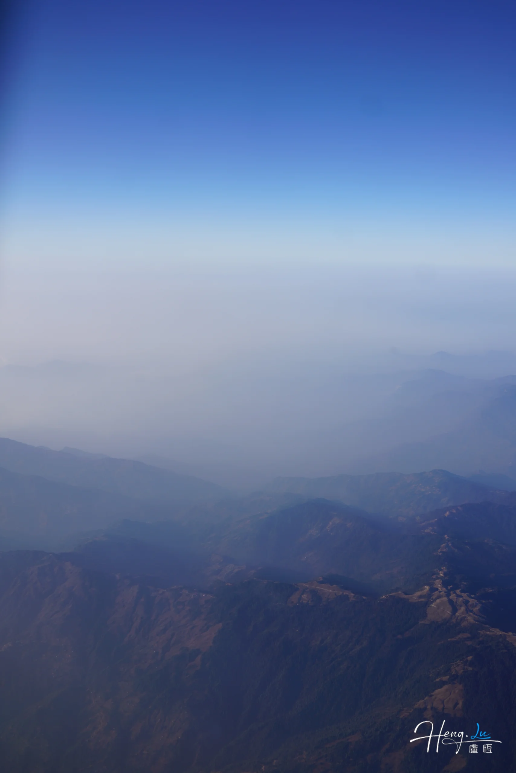 misty-mountain-range-under-blue-sky
