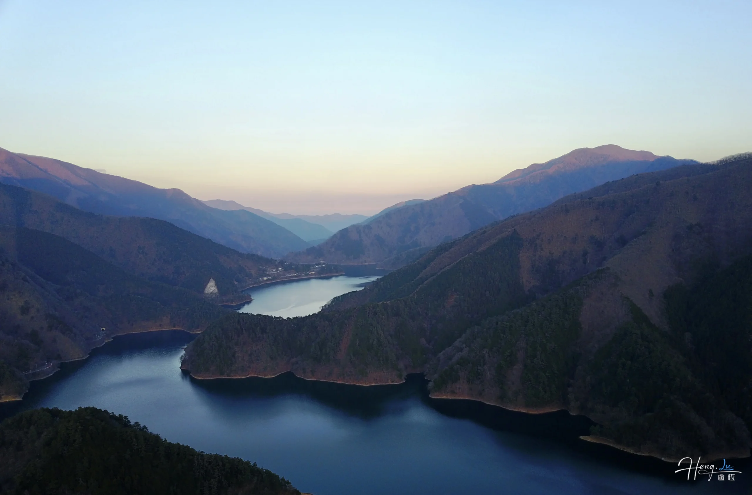 mountain-valley-reflecting-evening-sky-over-lake