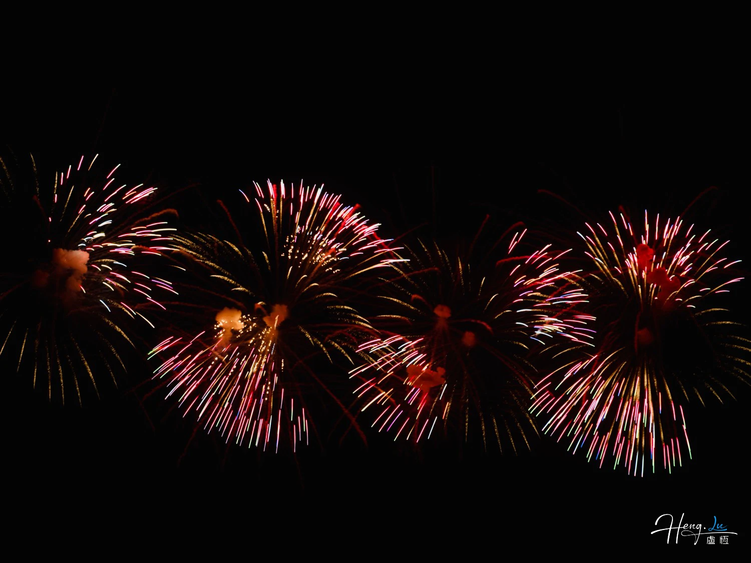 red-and-gold-fireworks-exploding-across-dark-sky