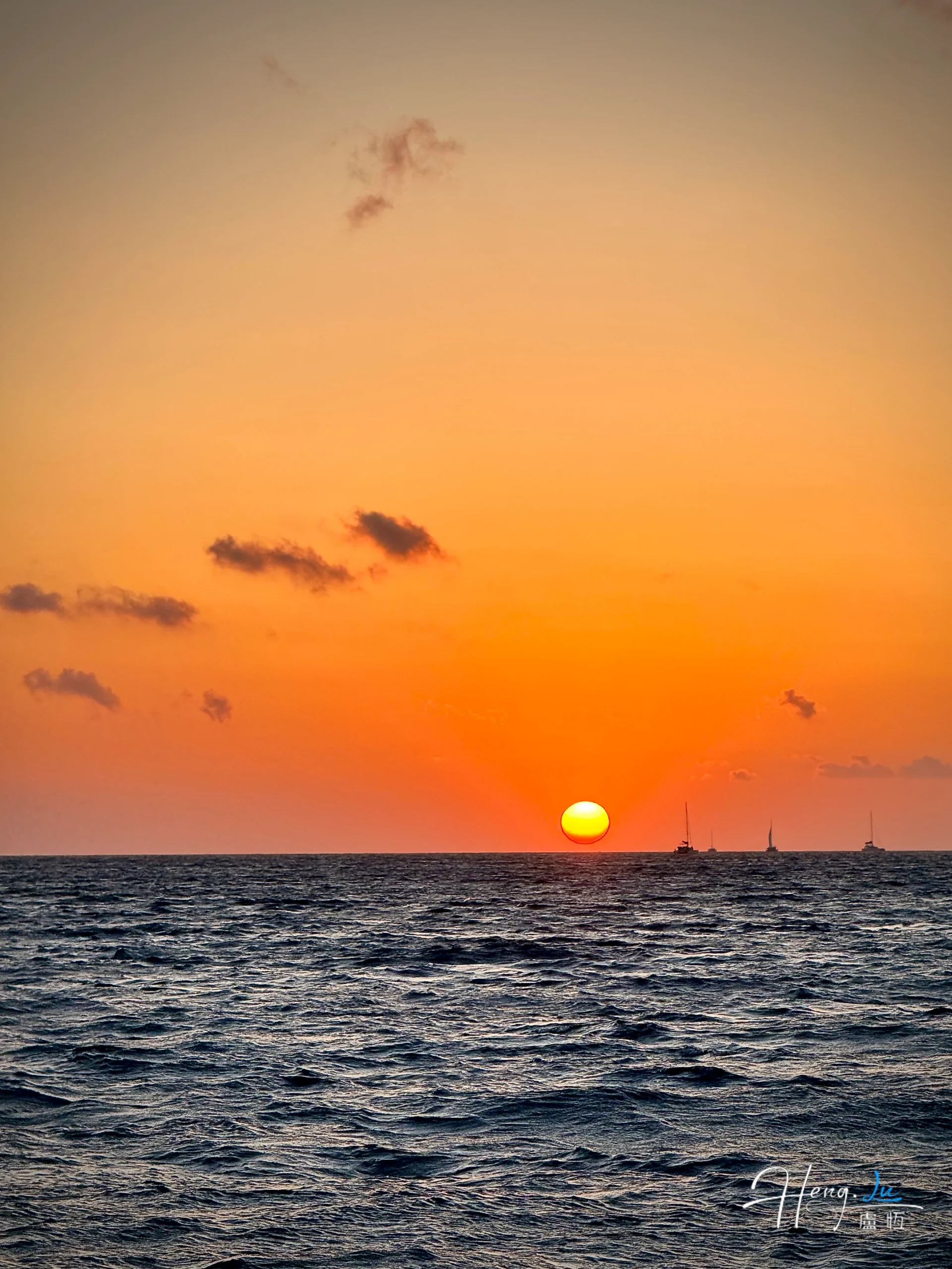 sunset-over-ocean-with-sailing-boats