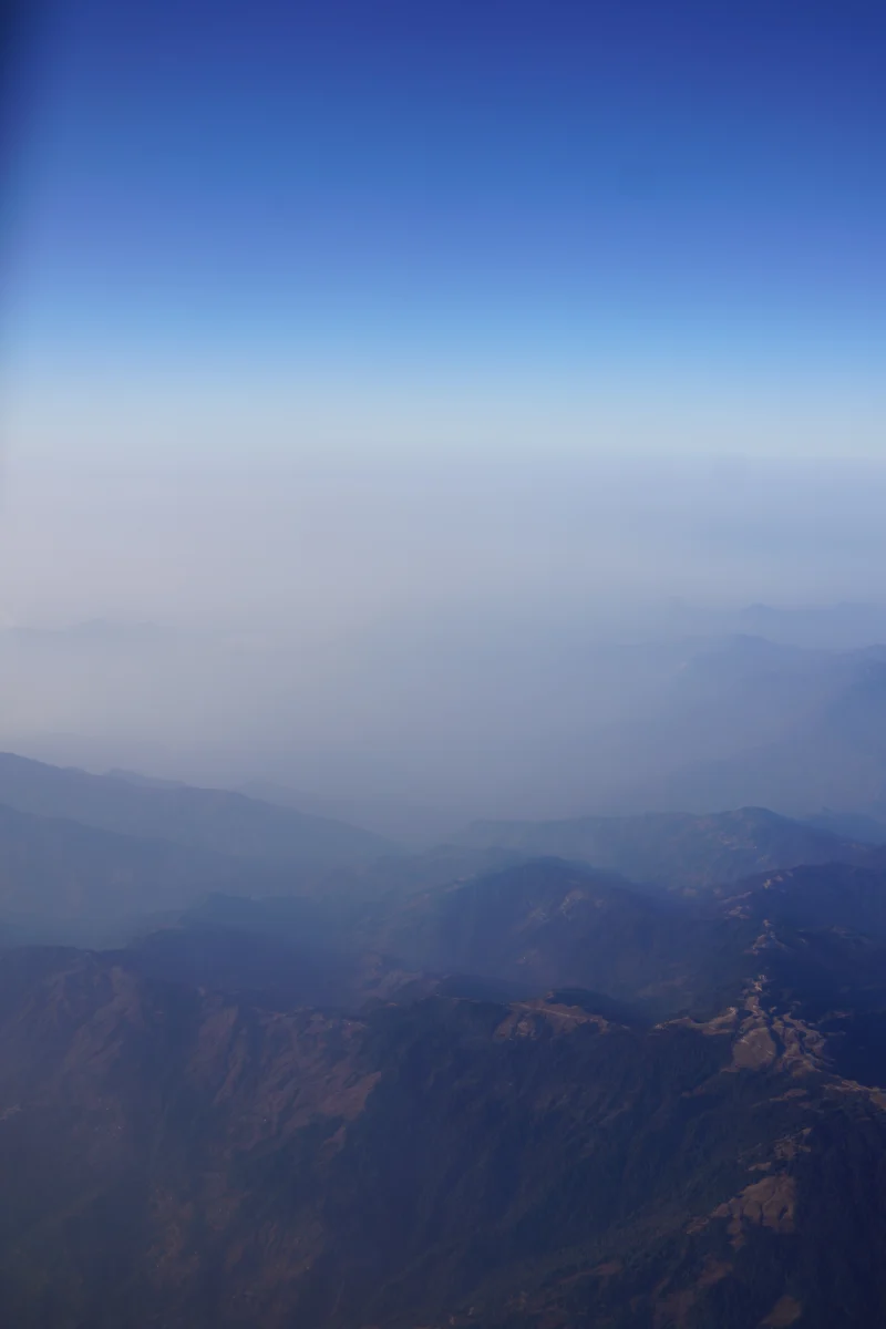 misty-mountain-range-under-blue-sky