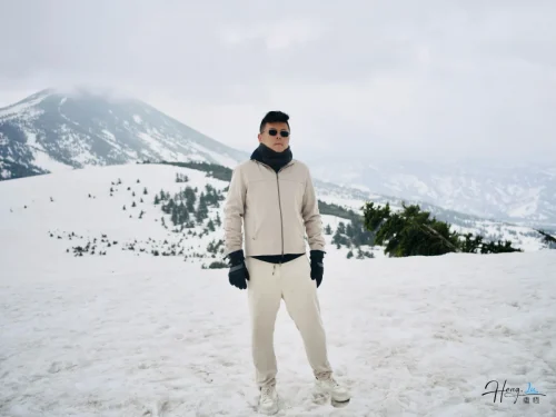 Luheng-standing-on-snowy-mountain-landscape