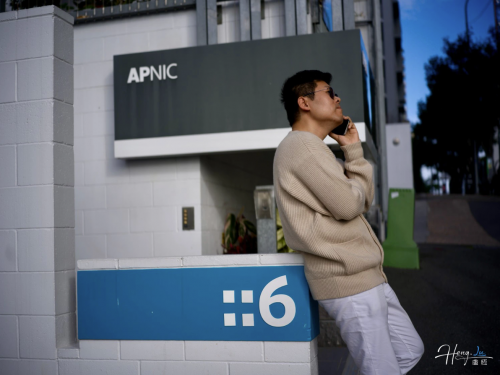 lu-heng-talking-on-phone-outside-apnic-office-building