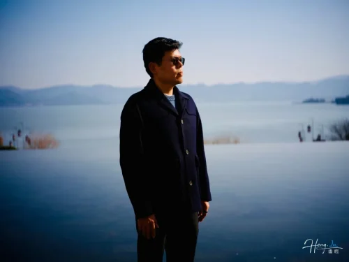 luheng-standing-by-lake-under-clear-blue-sky