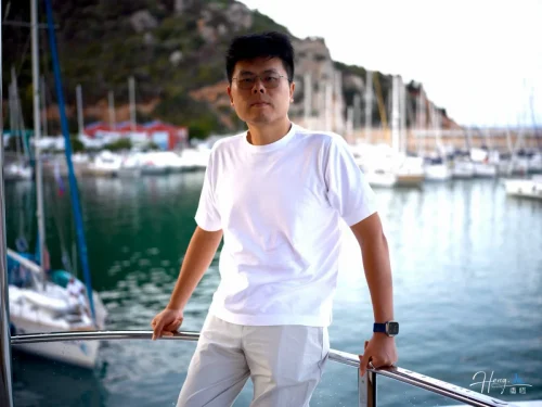 luheng-standing-on-yacht-with-marina-background