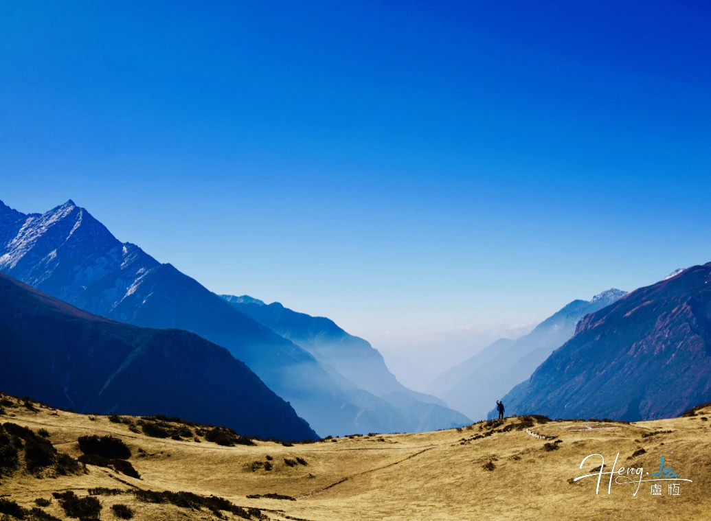 Misty mountain valley under a deep blue sky